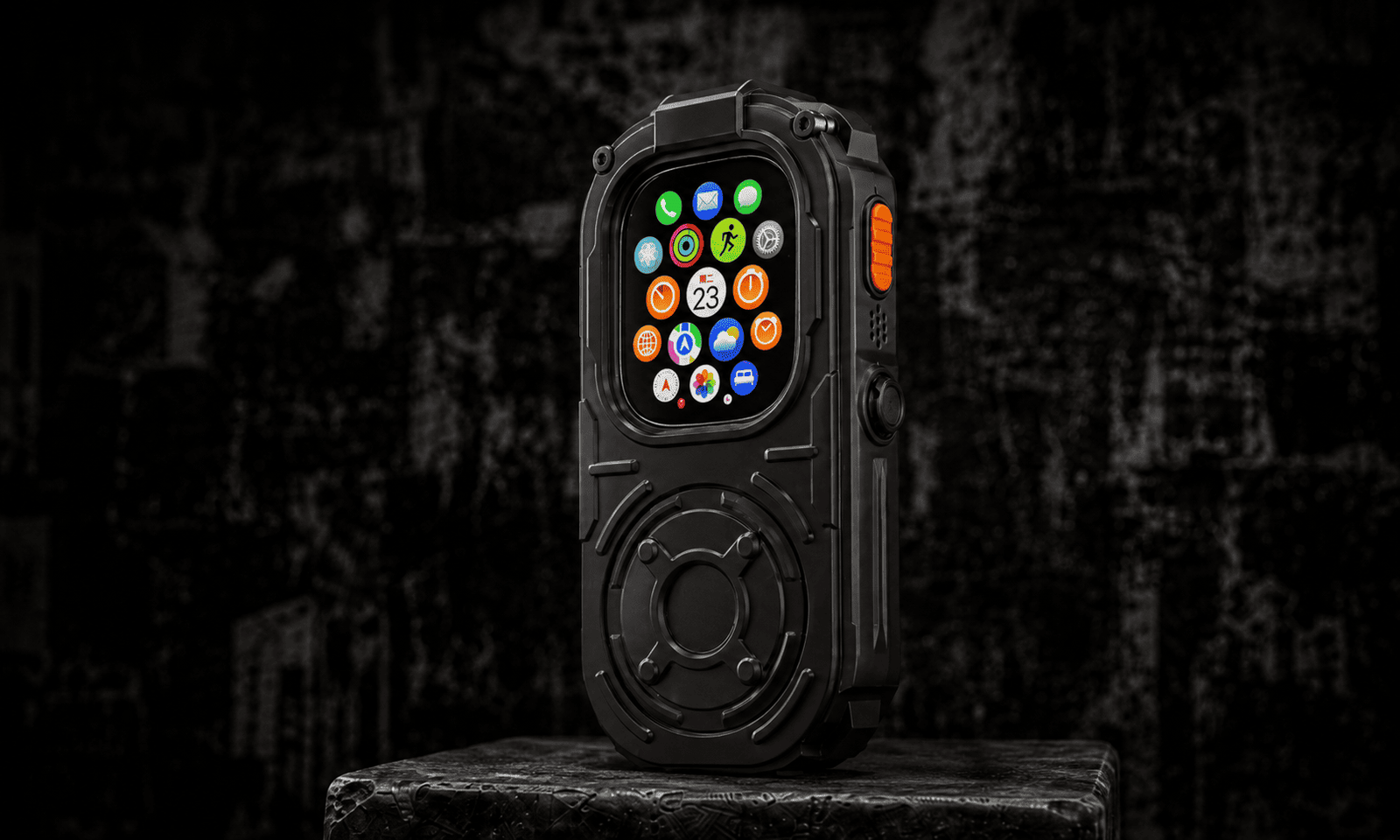 RePod Ultra gunmetal black Apple Watch Ultra handheld case standing on a rugged pedestal with Apple Watch Ultra installed, featuring a mechanical scroll wheel design and orange side button.